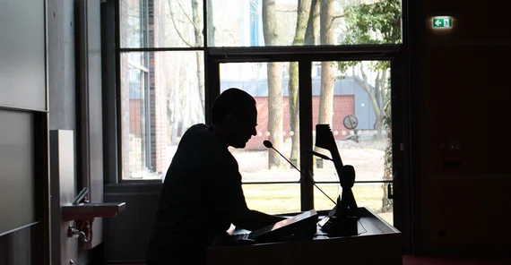 Person am Rednerpult.