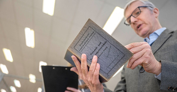 Das Personalverzeichnis der Pädagogischen Hochschule aus dem Studienjahr 1949/50. Ralf Müller hält das Personalverzeichnis der Pädagogischen Hochschule aus dem Studienjahr 1949/50 in den Händen.