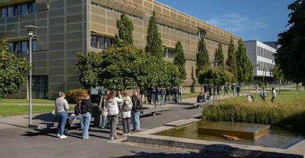 Studierende vor "Goldenem Käfig" am Campus Golm.