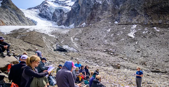 Gruppe von Menschen rastet bei einer Tour durch die Berge.