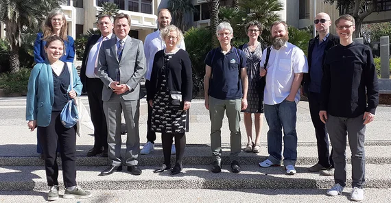 A group of people on the stairs in front of a builing.