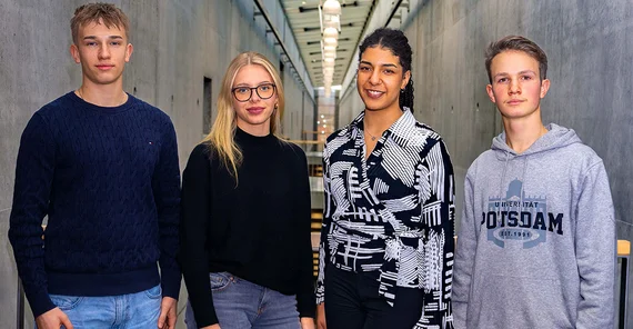 Four students in the University of Potsdam building.