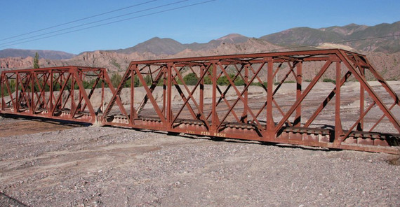 Stillge Stillgelegte Schienenbrücke über dem Rio Yacoreite, Humahuaca Tal, Nordwestargentinien. Innerhalb weniger Dekaden haben in vielen Teilen der Region Sedimente Flusssysteme „ersticken“ lassen. Im Humahuaca-Tal führte der Überschuss an Sedimenten zu einem Anstieg des Flussbettes von drei bis vier Metern und schließlich zur Stilllegung des lokalen Schienennetzwerkes. (Foto: Taylor Schildgen).